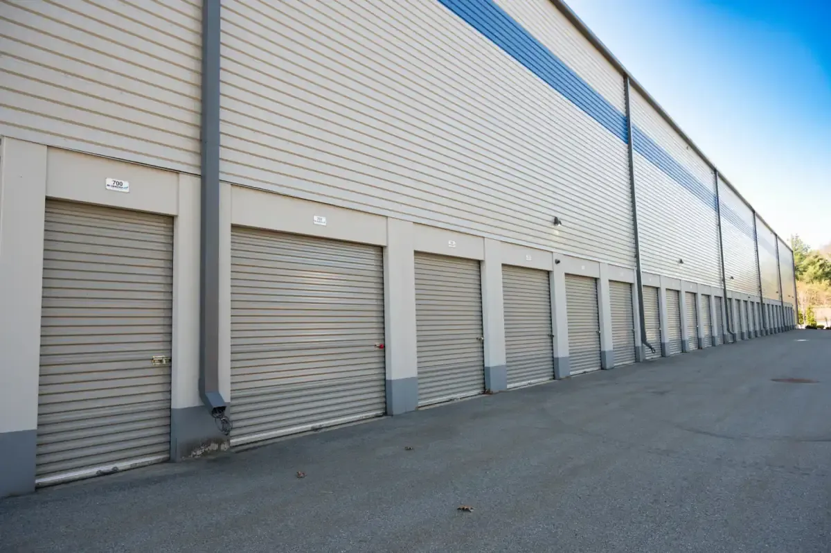 Row of outdoor drive-up storage unit doors at Bluebird Self Storage